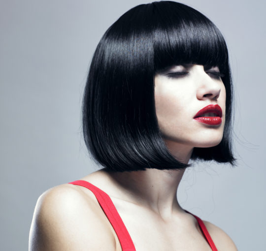 This is a retro haircut from the 1960s era.  Slick sleeky glosss black hair color.