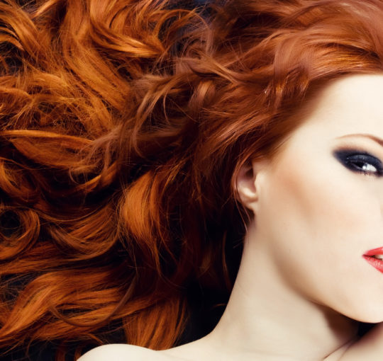 Beautiful natural looking red hair color on large bouncy curls