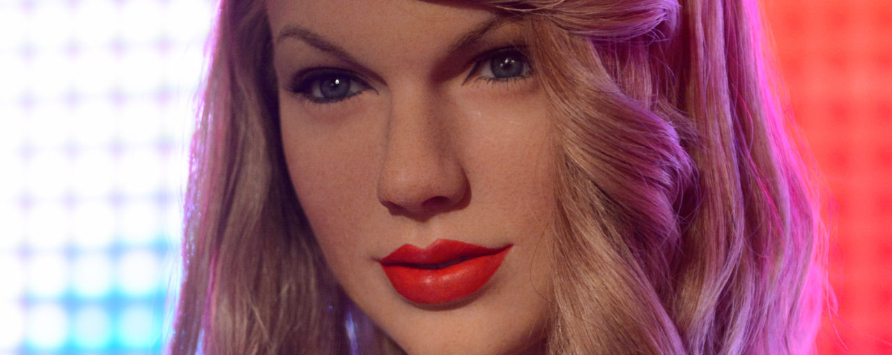 Taylor Swift- The medium blond flaxen color is drab and the bang curl is a bad rertro idea